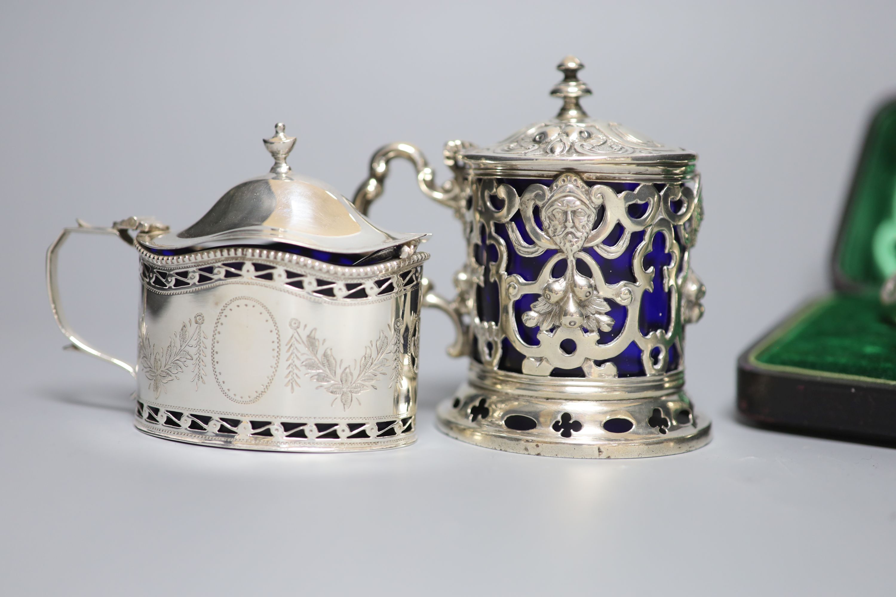Four mustard pots, various, including a George III oval silver mustard, London 1789, Henry Chawner